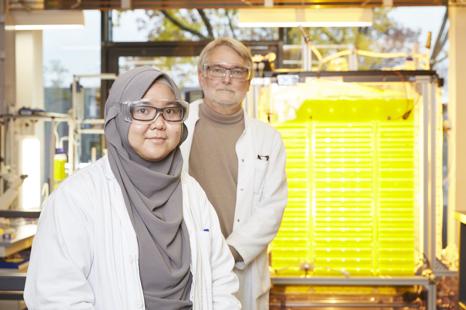 Portrait of Nadia Prasetija and Prof. Pollet in front of the reactor