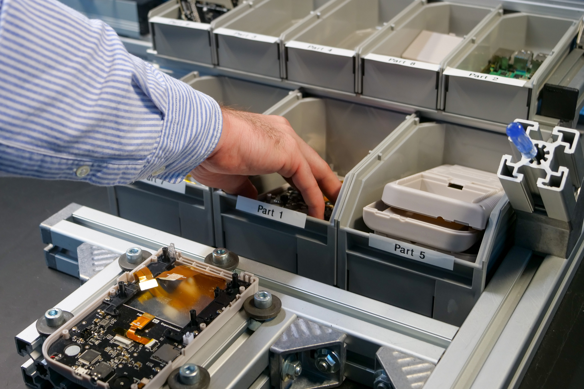 Hand, die nach einem kleinen Bauteil greift