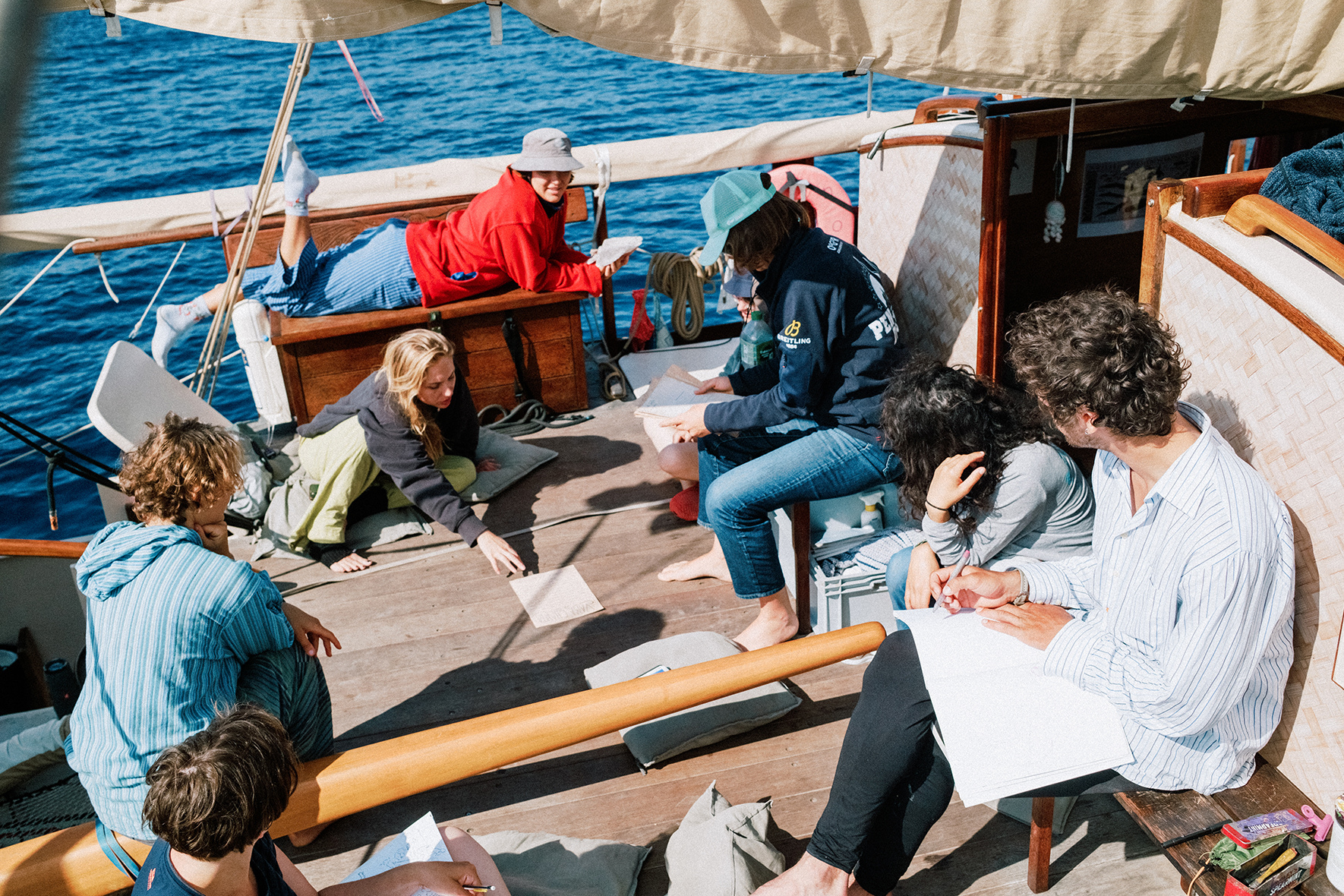 Students, lecturers and crew on the deck of the boat.