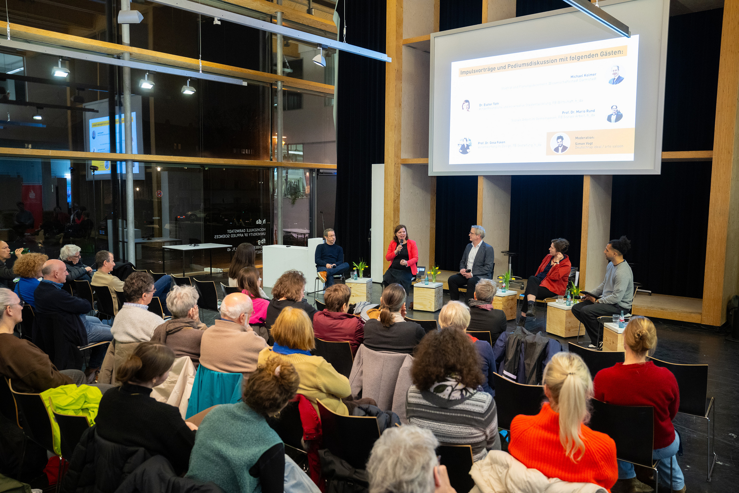 View across the audience to the panellists