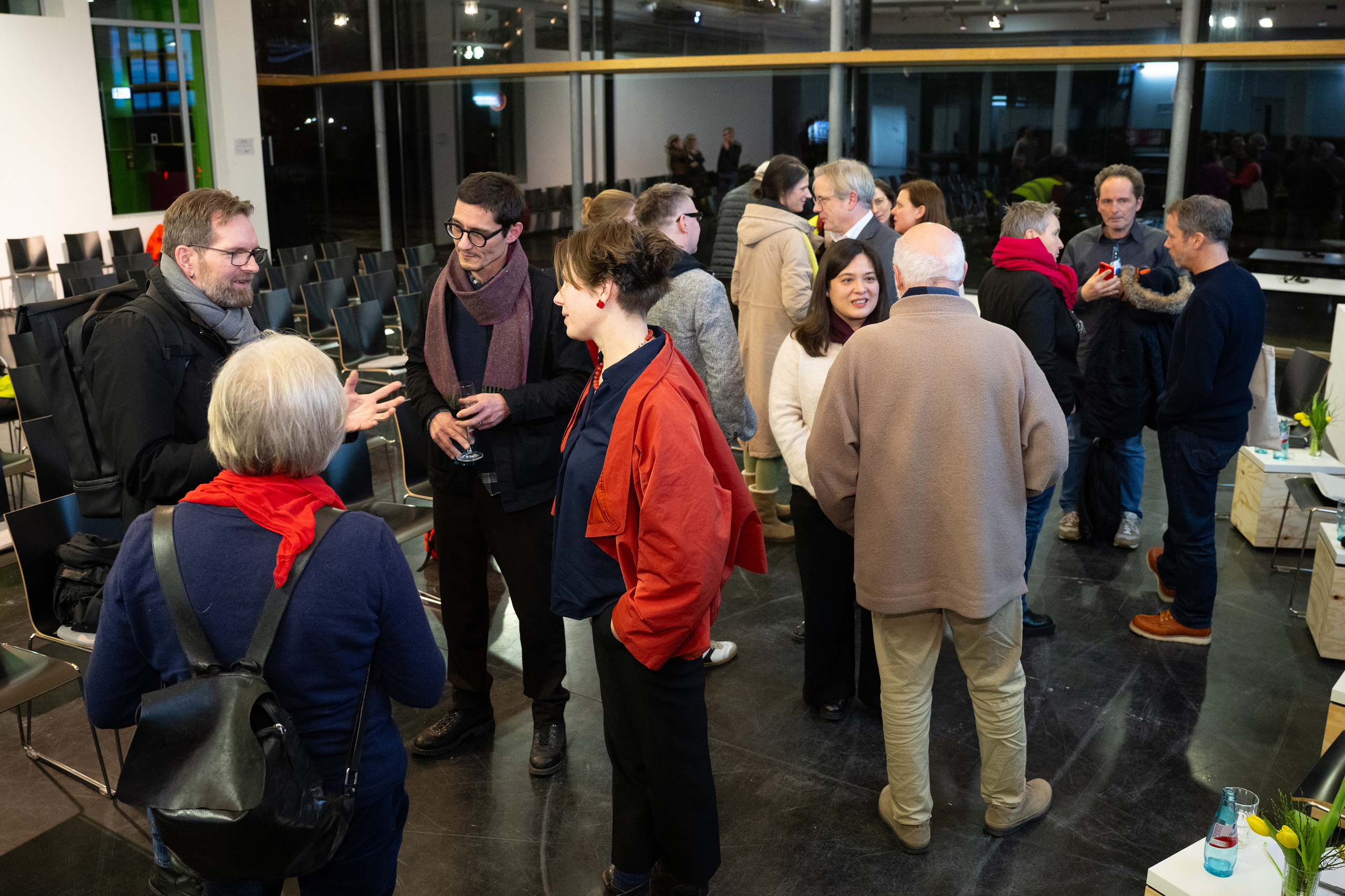 Panellists and guests standing together in discussion