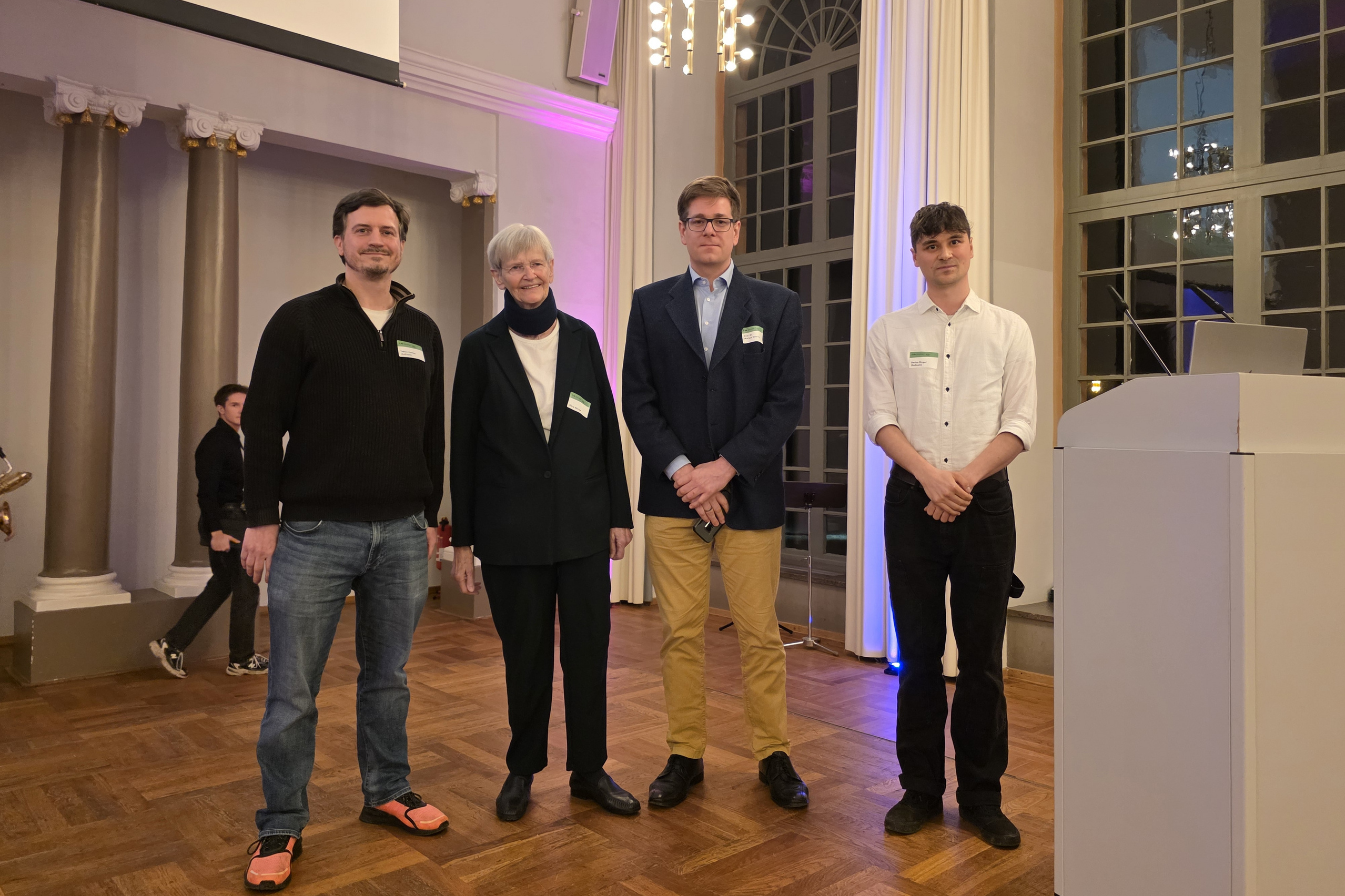 Tobias Combé and Darius Dinger on stage with Dörte Wörner and Prof. Dr. Markus Döhring at the award ceremony on 5 December 2025..