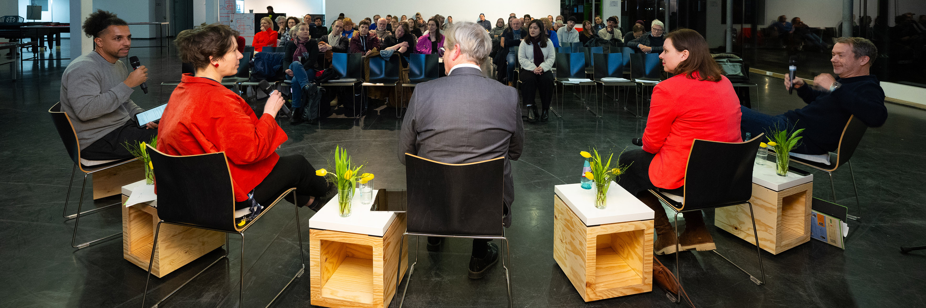 Die Panelisten im Vordergrund, das Publikum im Hintergrund
