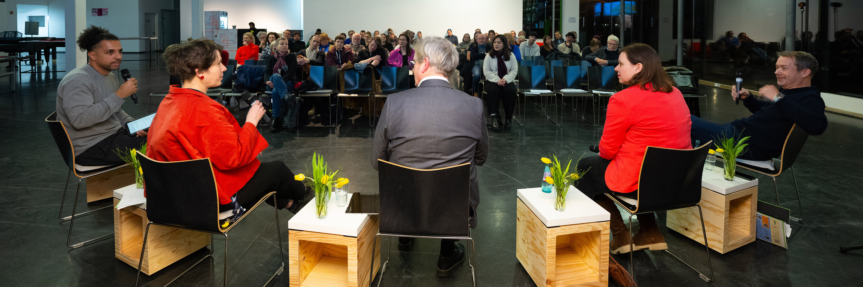 Blick in den Saal mit den fünf Panelisten im Vordergrund