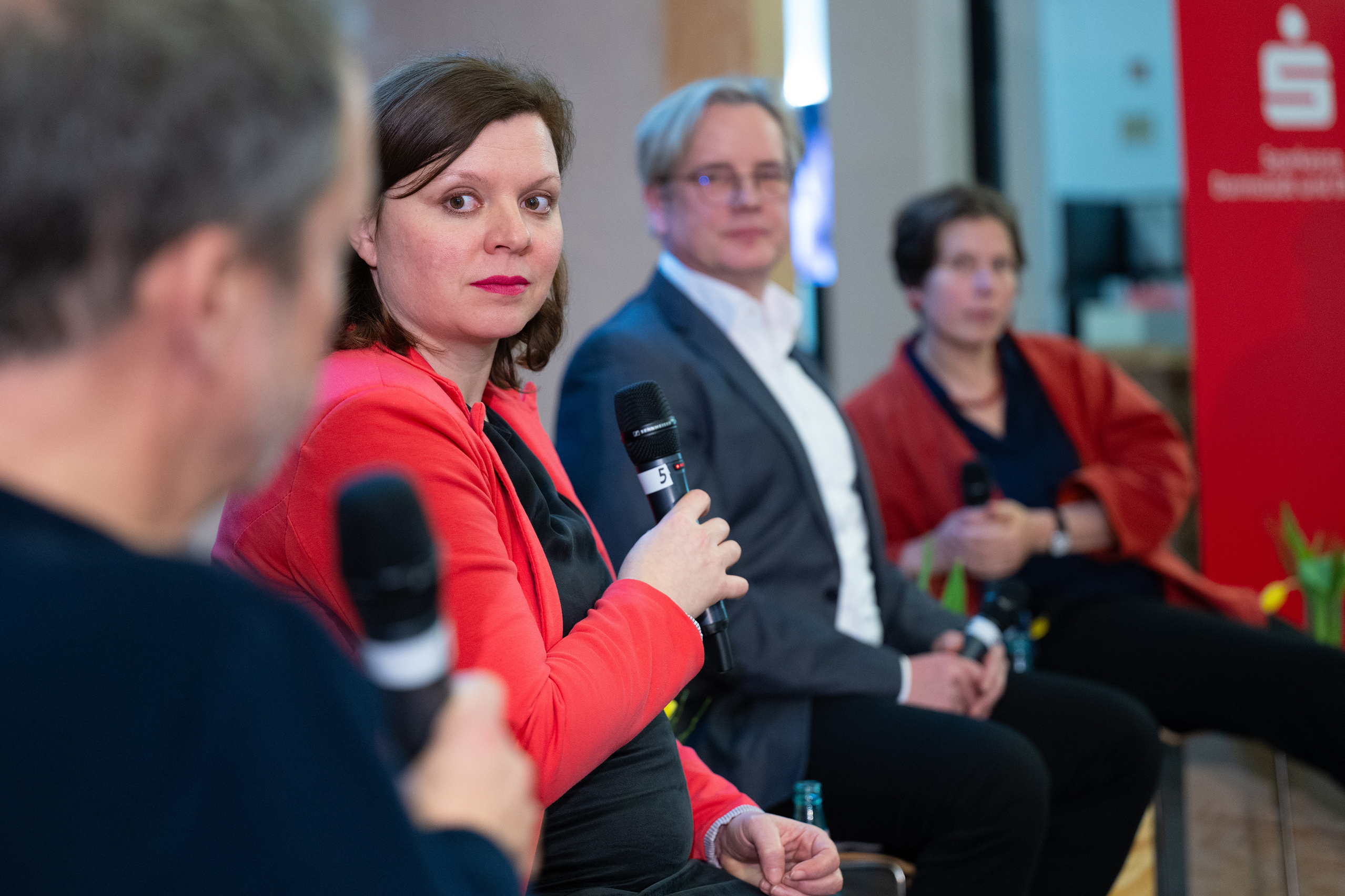 The four panellists: Michael Kolmer in the foreground, Eszter Tóth in the centre