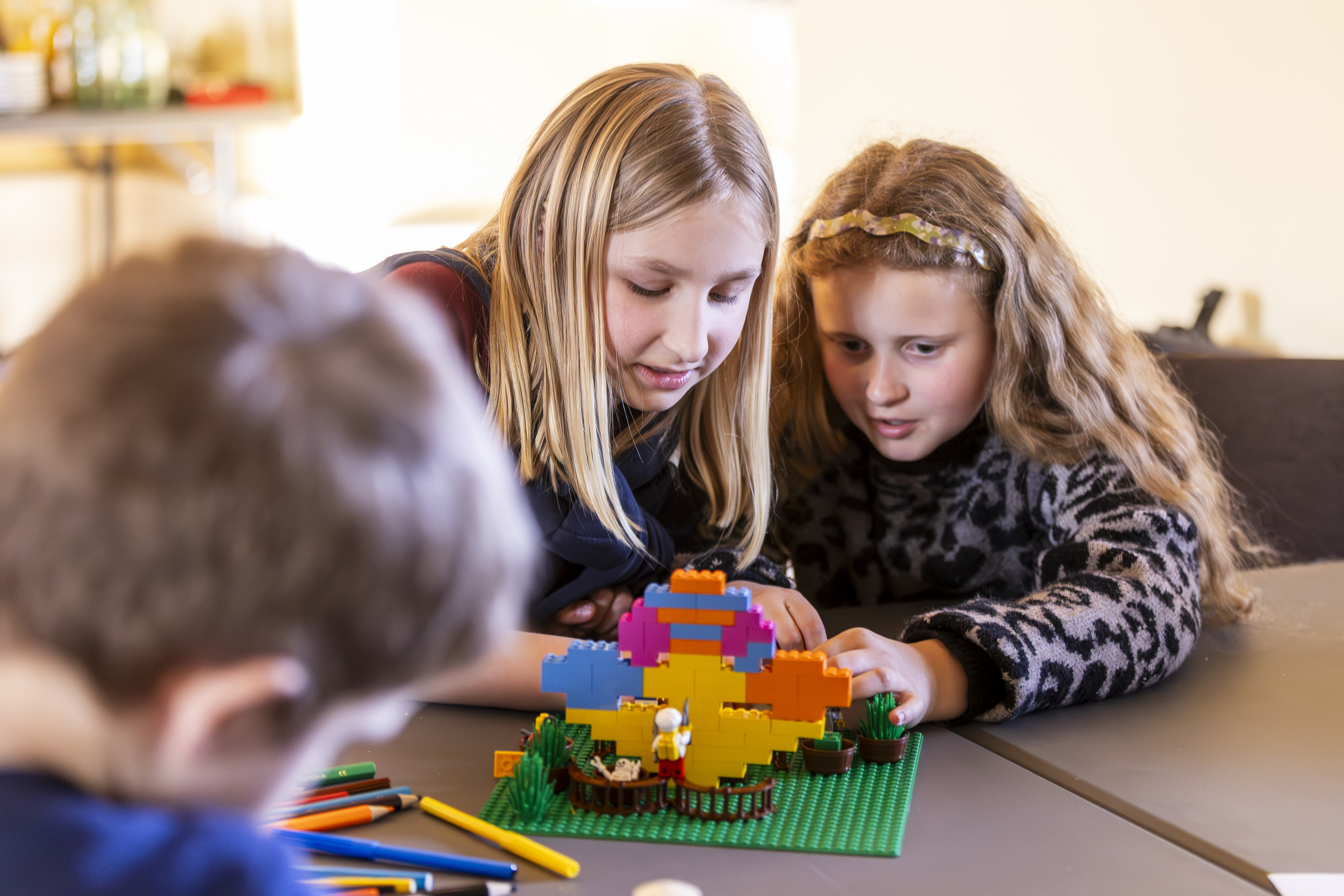 Zwei Mädchen, die an einem Legomodell basteln