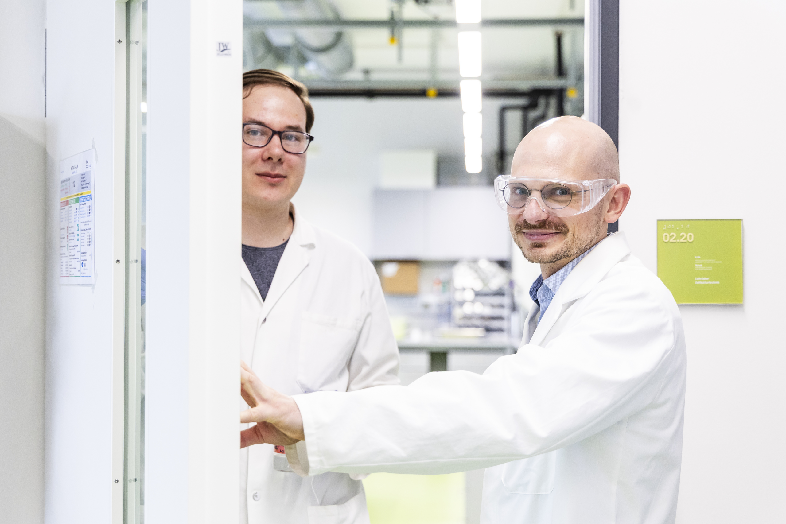 Prof. Dr. Michael Becker und Doktorand Lennart Suckowin weißen Laborkitteln