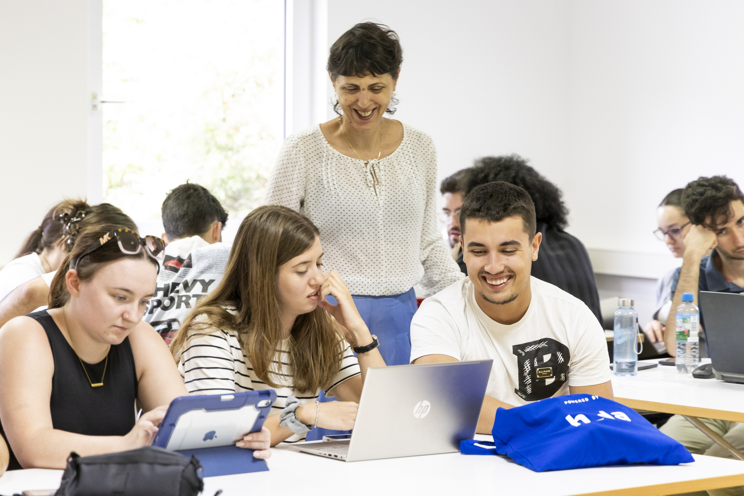 Groups of smiling participants with one of the lecturers