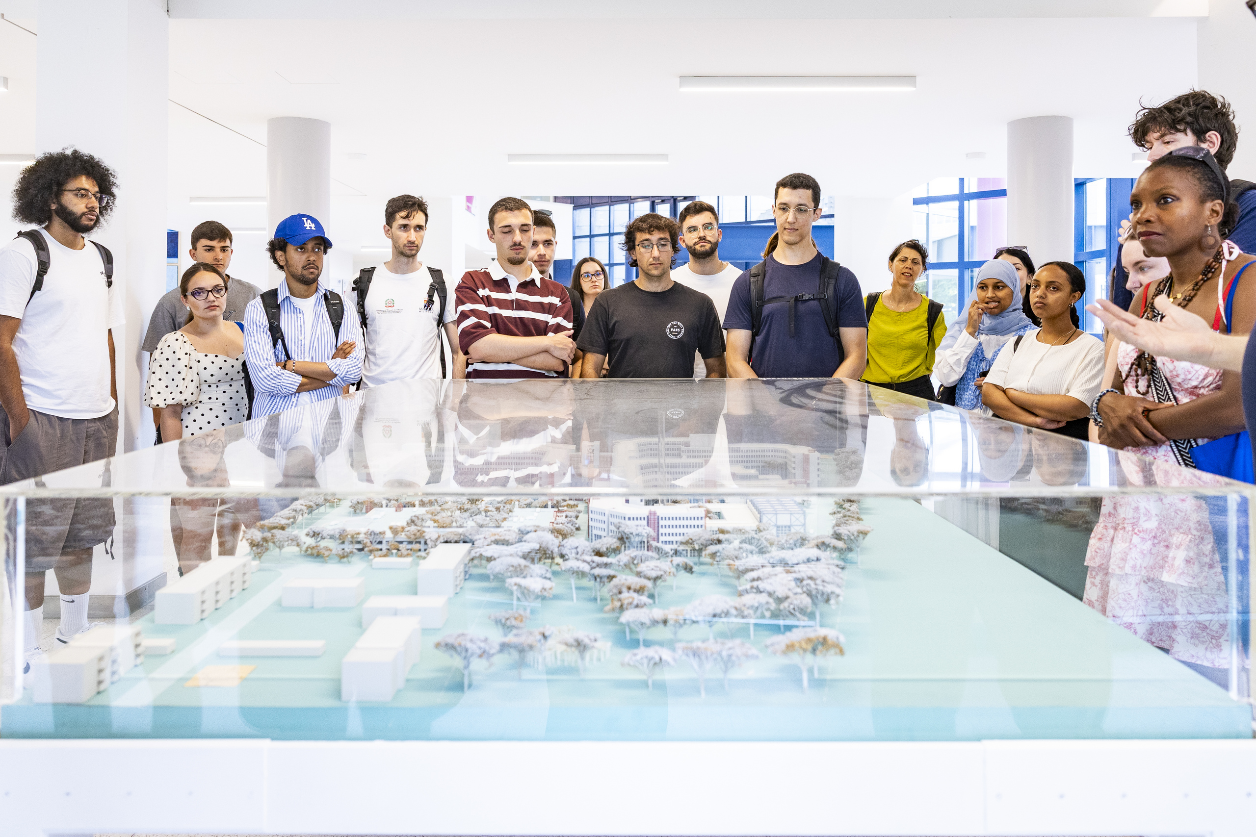 Group of students gathered around a model of a city in HUB31
