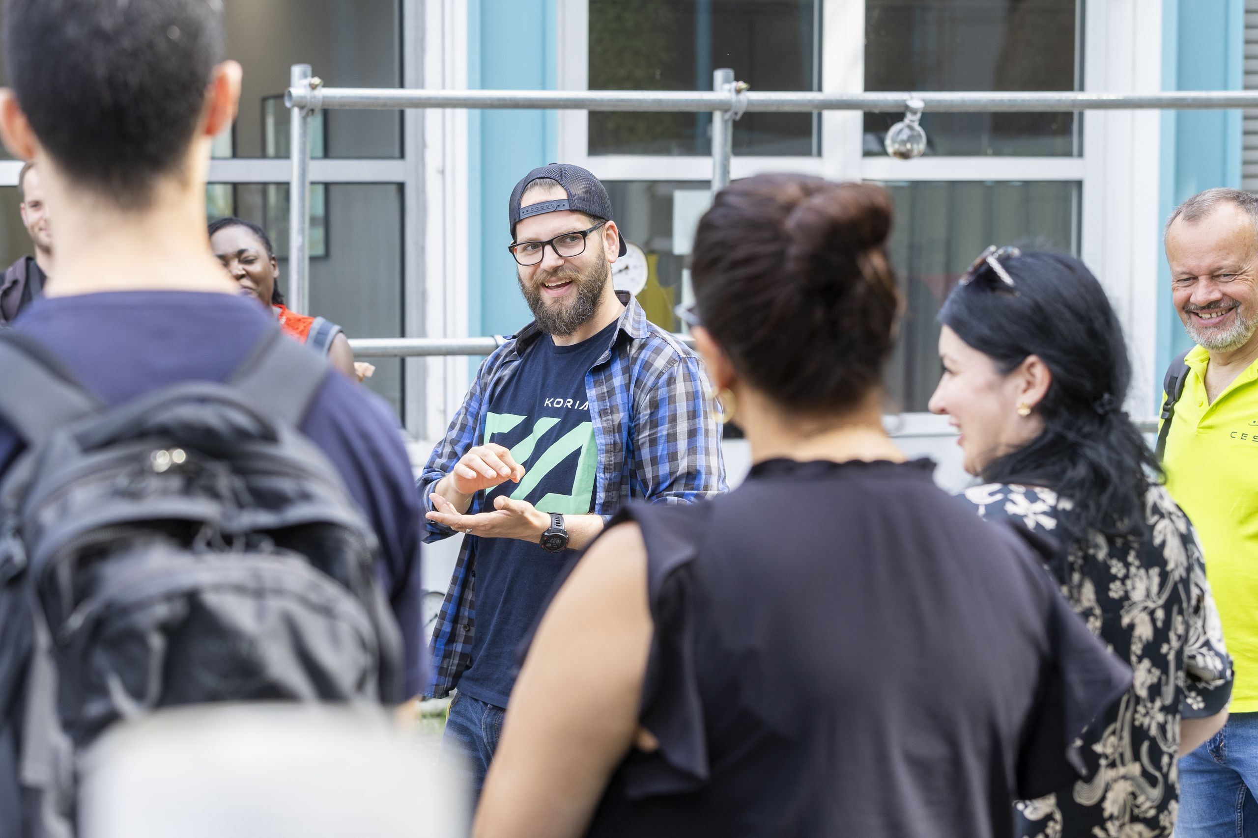 A young start-up entrepreneur in the middle of a group of students and lecturers