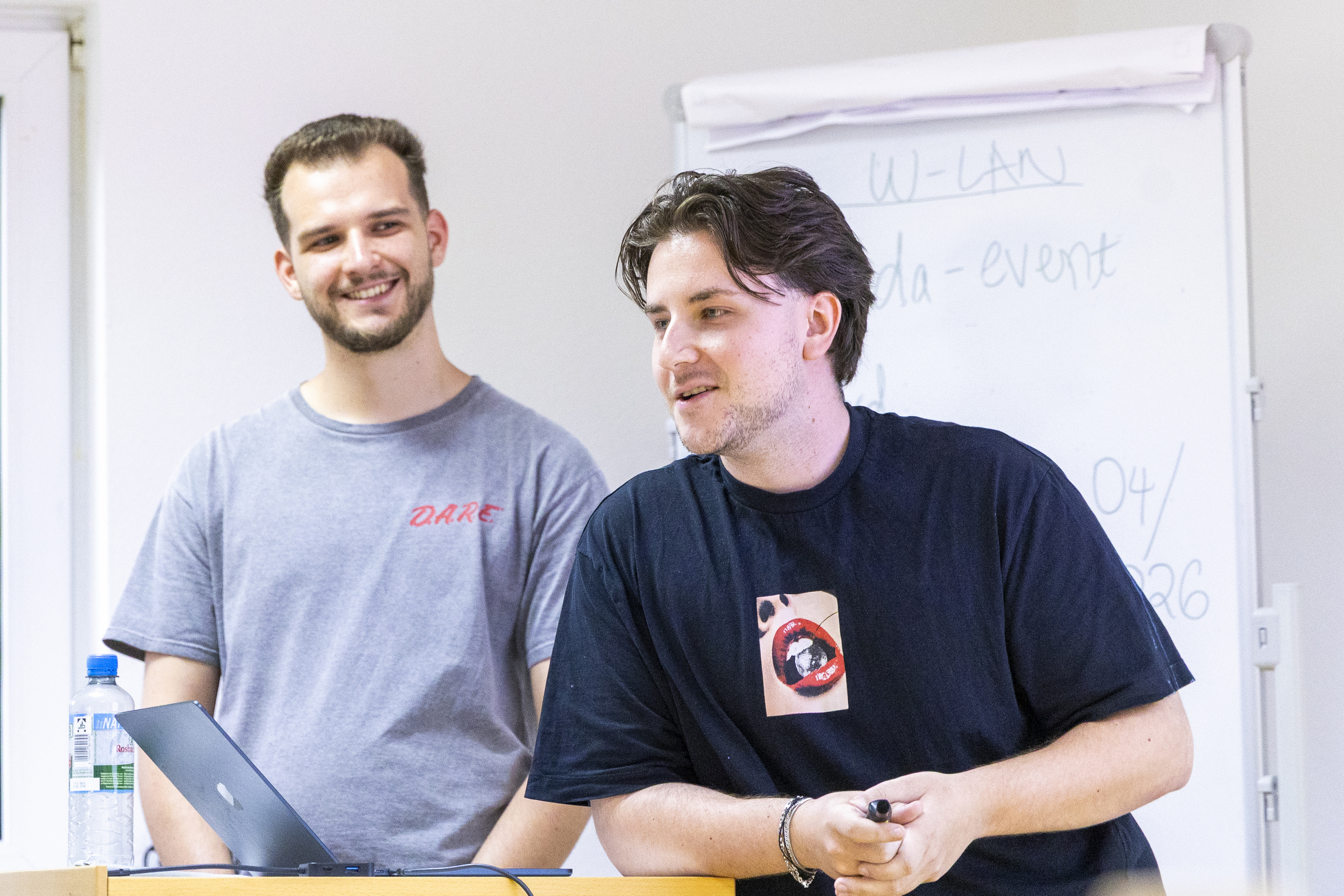 Two smiling students give their presentation 