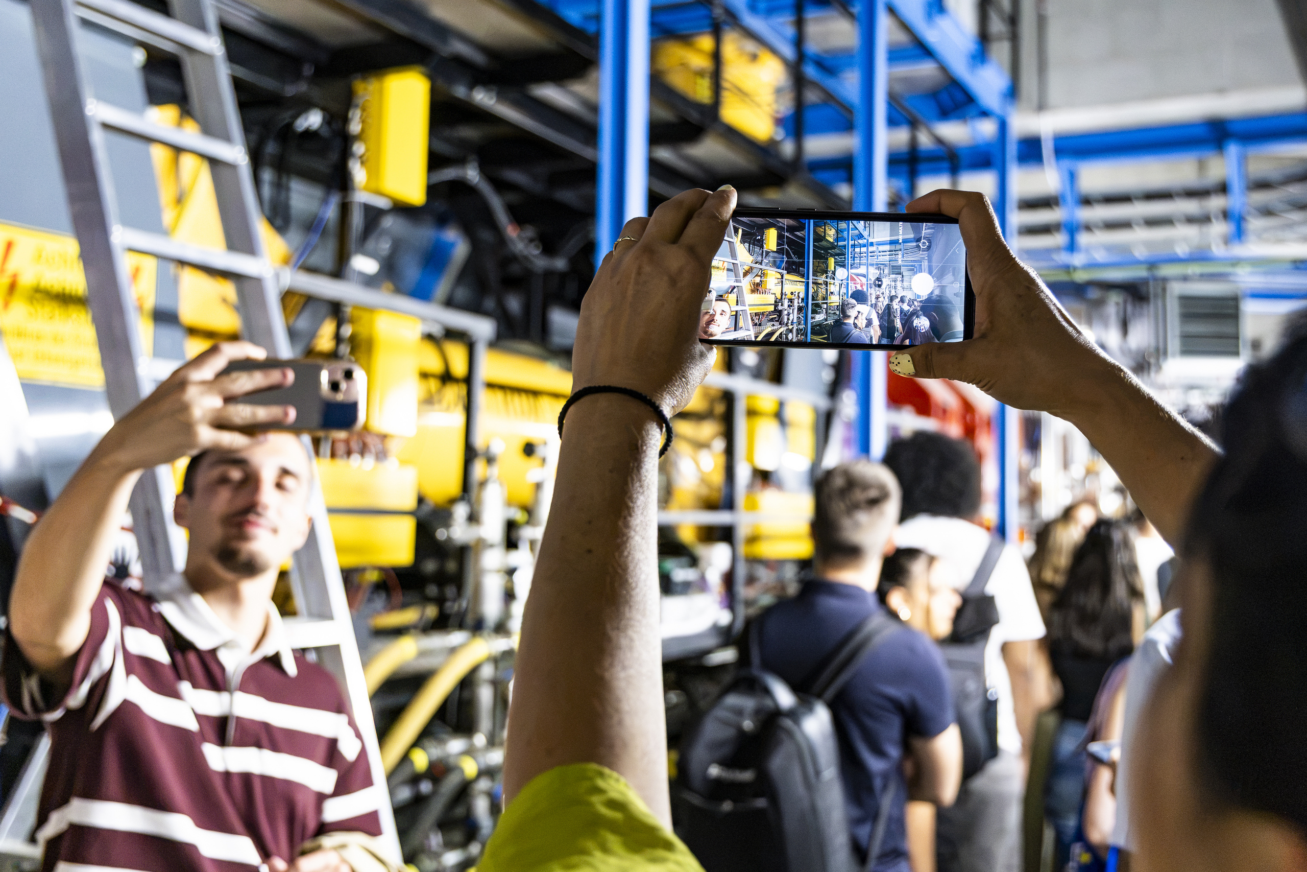 Students take photos with their mobile phones during the guided tour